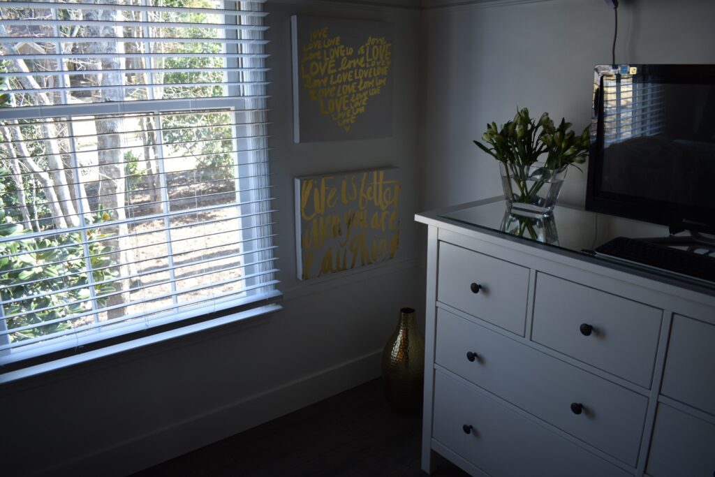 DIY Bedroom Makeover adding wood trim detail, moldings and baseboards to the walls.